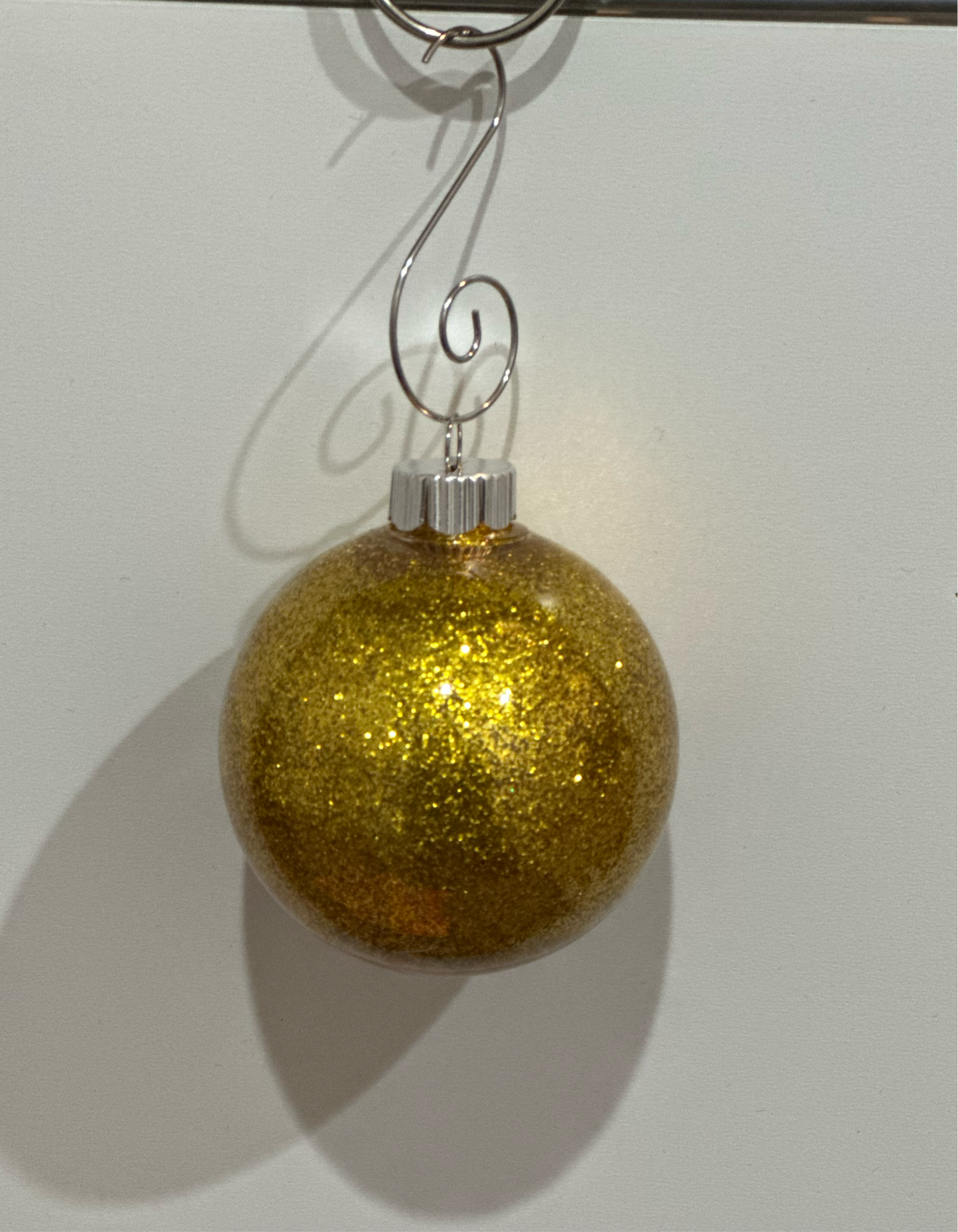 glittered plastic ornament with metal hook